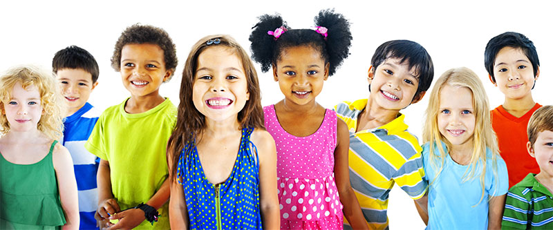 A diverse group of children and teenagers in colorful clothing, posing for a photo with smiles.