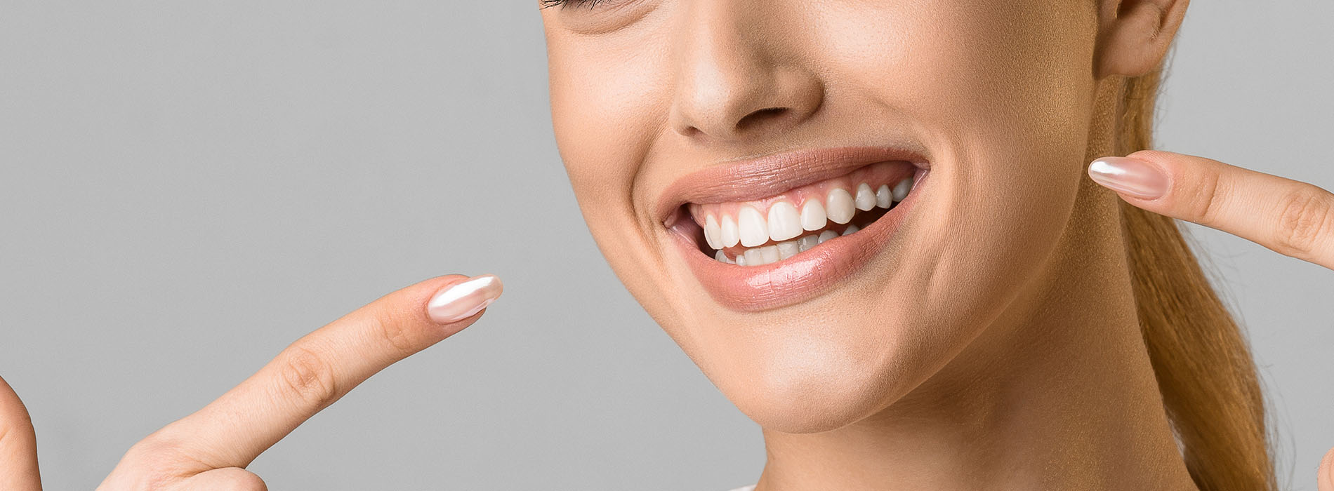 Woman with radiant smile, celebrating a positive moment.